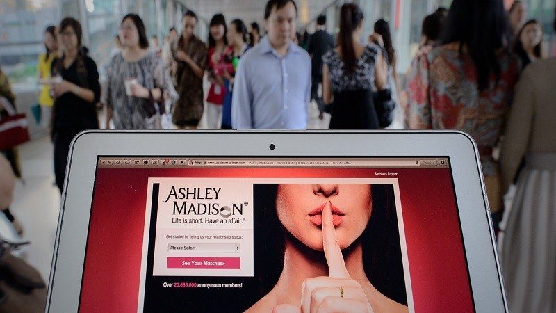 TO GO WITH AFP STORY LIFESTYLE-HONG KONG-INTERNET-SEX, FOCUS by Aaron Tam This photo illustration taken on August 20, 2013 shows the homepage of the Ashley Madison dating website displayed on a laptop in Hong Kong. The founder of a dating service promoting adultery is setting his sights on China's cheating hearts after a controversial launch in Hong Kong. AFP PHOTO / Philippe Lopez (Photo credit should read PHILIPPE LOPEZ/AFP/Getty Images)